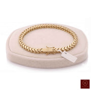 14K yellow gold 5mm Franco chain bracelet resting on a cream velvet pillow display with a Veka Jewelry logo.