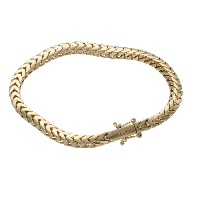 Top-down view of a 14K yellow gold 5mm Franco bracelet laid out in an oval shape showing the full chain structure