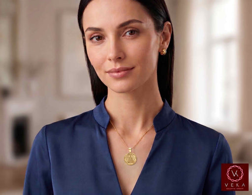 Woman wearing the 14K Yellow Gold Caridad del Cobre Medal Pendant on a chain, Veka Jewelry.
