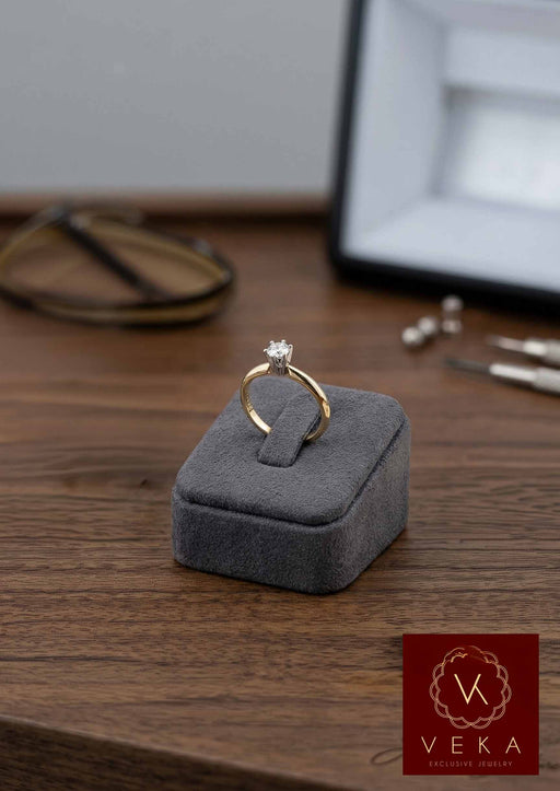 VEKA Jewelry 14k yellow gold diamond solitaire ring on grey velvet display base, detailed view.