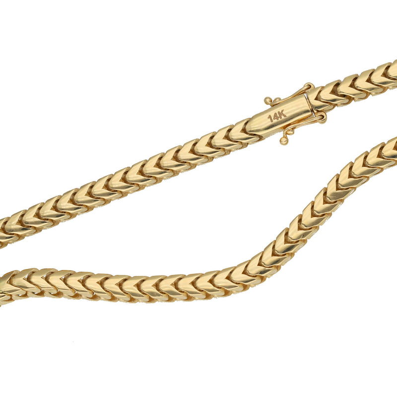 A close-up shot focusing on the sleek Box lock cylinder clasp mechanism with its dual safety latches, securely attaching one end of the 4mm 14K yellow gold hollow Franco chain 