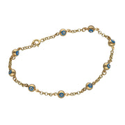 A 14 karat gold bracelet with evil eye beads on a lobster lock.