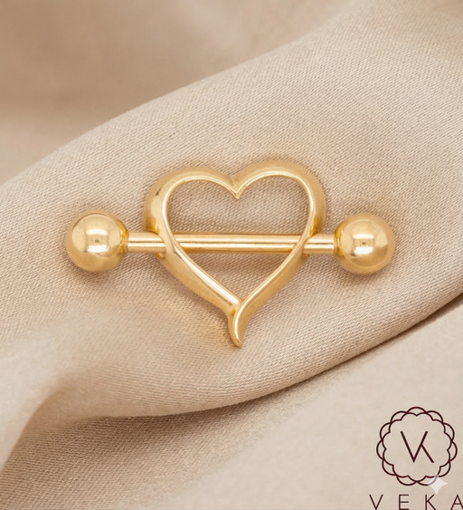 Gold heart-shaped barbell Nipple Piercing on a beige fabric silk background with Veka branding.