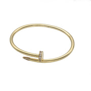 14k Gold Nail bracelet with clear zirconium stones accents on a white background