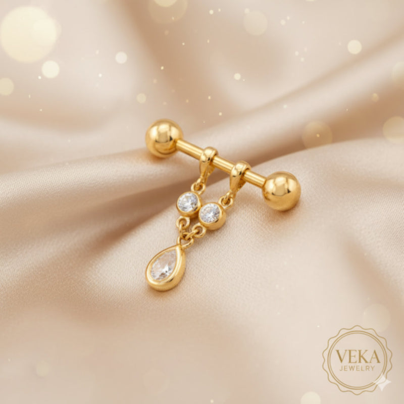 14K yellow gold nipple piercing barbell with teardrop dangle and round crystals on luxury champagne silk background - Veka Jewelry