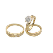 A Close up of set of three 14 karat gold rings with zirconia stones, including one engagement ring and two bands for women and men with the engraving Forever in both men and women band. 