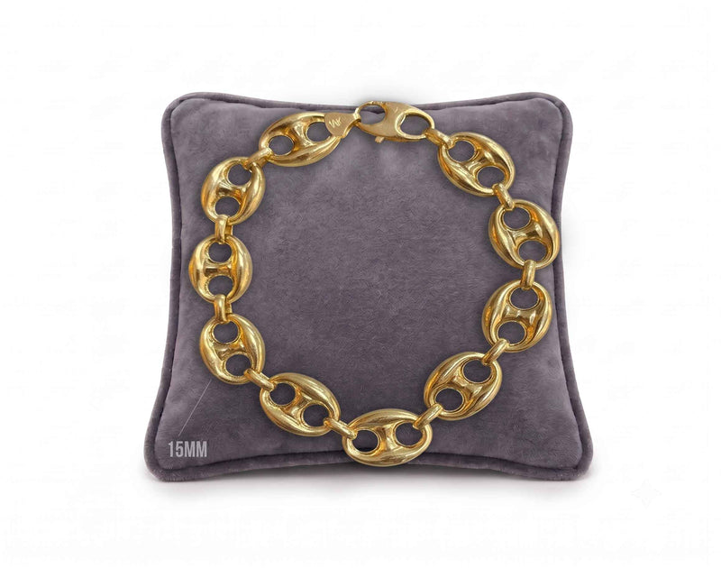 15mm puffed mariner link bracelet in 10K yellow gold displayed on a grey velvet pillow by Veka Jewelry