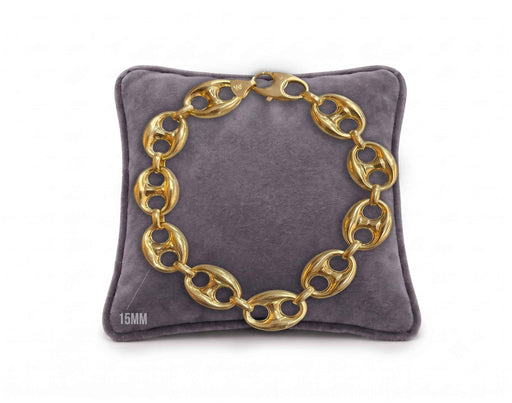 15mm puffed mariner link bracelet in 10K yellow gold displayed on a grey velvet pillow by Veka Jewelry