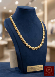 Professional 10K yellow gold elephant stampato necklace on a blue velvet bust, 8.1mm width, 18 inches length.
