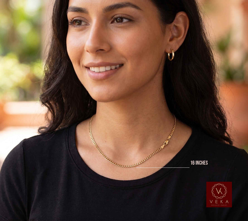 Latina model wearing a 16-inch 2.5mm solid 10k yellow gold Italian curb chain necklace and gold hoop earrings