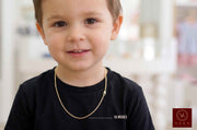 Young boy wearing a 16-inch 2.5mm solid 14k yellow gold Italian curb chain necklace for children