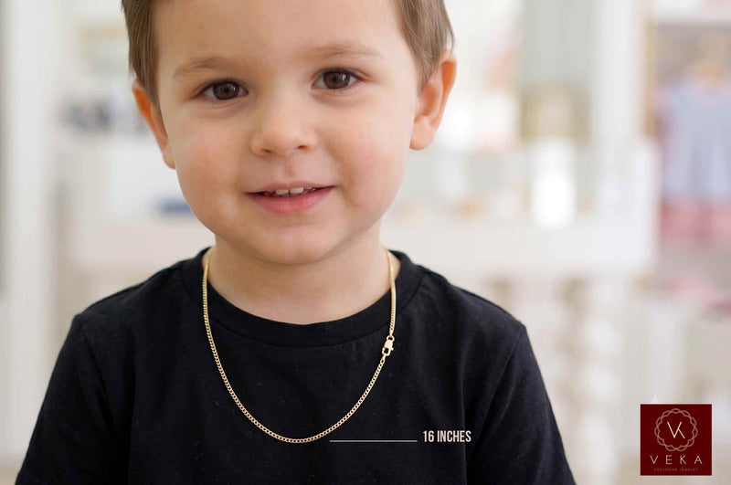 Young boy wearing a 16-inch 2.5mm solid 14k yellow gold Italian curb chain necklace for children