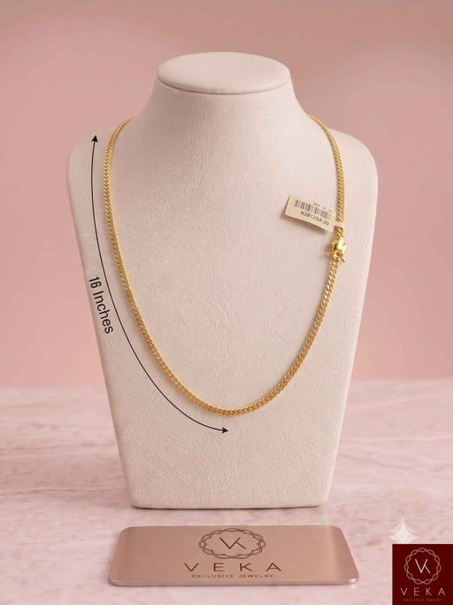 A 16-inch Veka Jewelry 3mm solid Miami Cuban link chain in 14K yellow gold displayed on a white neck bust with a pink studio background.