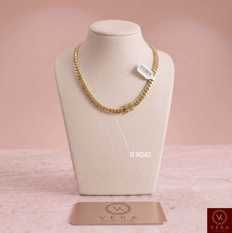 18-inch 14k real gold Cuban link chain 6mm width on a jewelry display with a pink background.