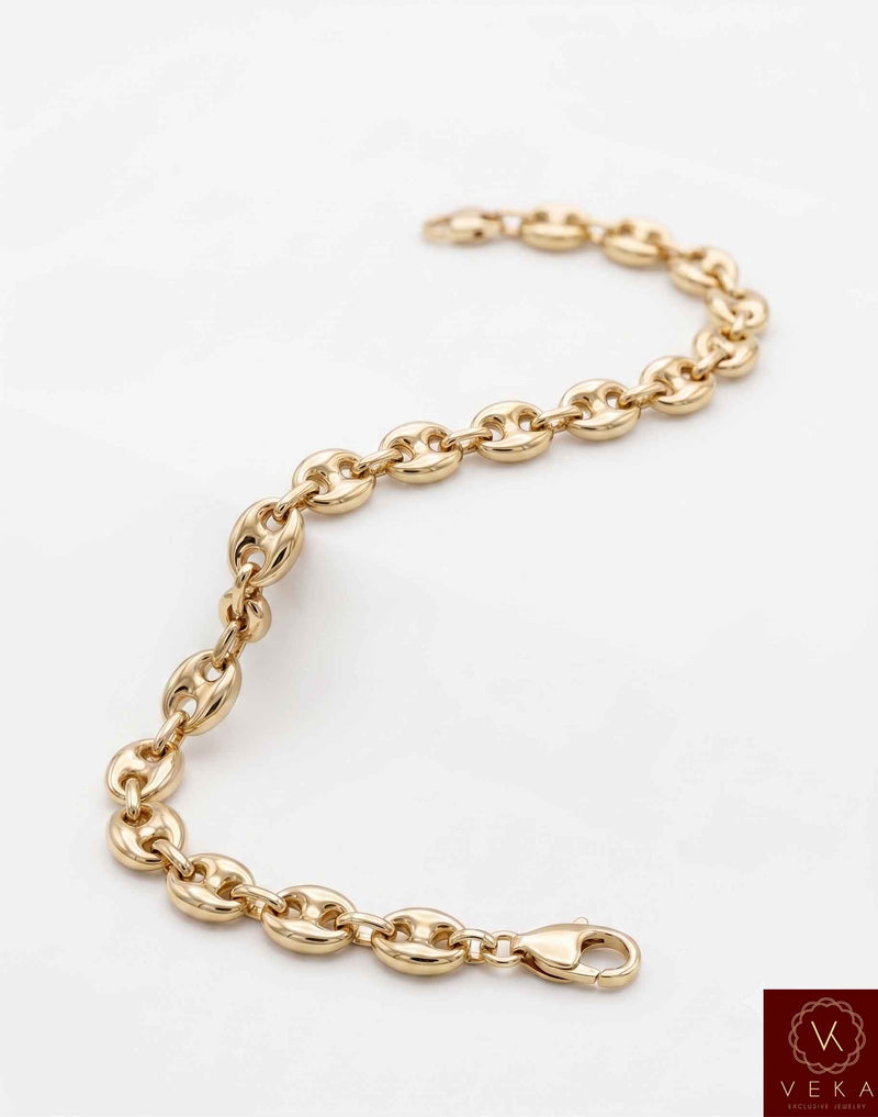Flat view of a 7mm men's puffed mariner link bracelet showing the secure lobster lock in 14K yellow gold