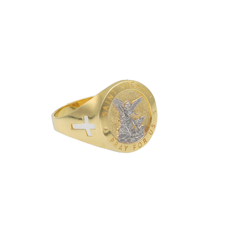 An angled studio product photograph of the 10K Two-Tone Gold Saint Michael Signet Ring, showing the detailed central medal and one side of the yellow gold band with a side cross cutout