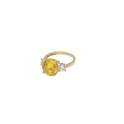 Yellow gold citrine ring with diamond-like zircon side stones - elegant three stone design in a white background