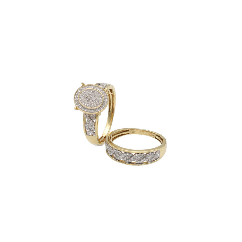 A 14 karat gold ring with a central engagement ring surrounded by a ceremony smaller band, both set with natural diamonds set on a white background showing the inside of one band.
