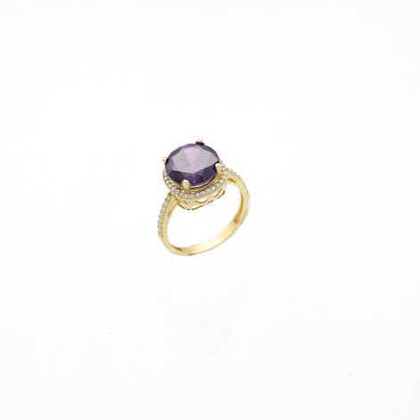 Synthetic Amethyst Stone on top a yellow real gold ring. The purple stone is set in 4 prongs, and the base is surrounded by cubic clear zirconium stones. 