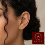 real Gold Septum Cartilage Piercing on a Latina Model with black hair. 