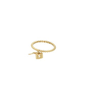 Side view of 14K yellow gold heart lock and key ring with cubic zirconia accents on white background