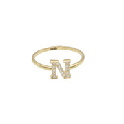 A yellow gold ring with a single initial 'N' adorned with zirconia stones.