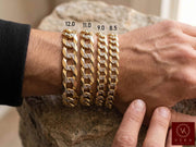 Solid Two Tone 14k Gold Cuban Link Men Pave On Male Model Hand with a Rock table on the background.
