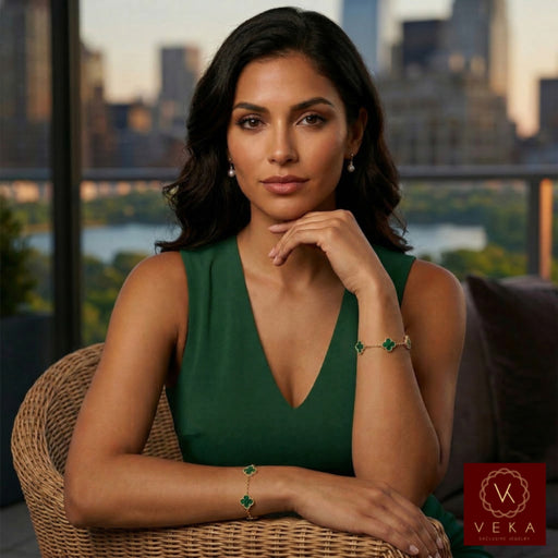 Elegant Latina model wearing the 10k gold malachite clover bracelet in a luxury outdoor setting, showcasing the 9.5mm charm scale