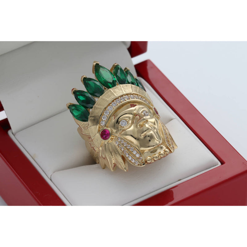 Close-up angled view of the Men's 14K Yellow Gold Indian Chief Ring (13.3g) by Veka Jewelry, featuring a detailed headdress set with emerald green marquise-cut synthetic stones and clear cubic zirconia accents, displayed in a red ring box