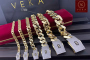 A collection of 6 genuine 10k gold Monaco chain bracelets in various sizes displayed on a luxury red velvet box by Veka Jewelry and in this specific picture the 17MM wide is tagged.