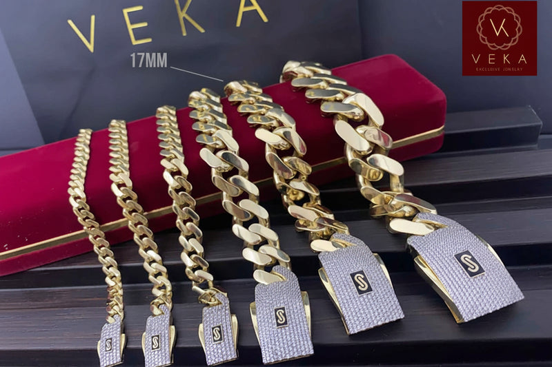 A collection of 6 genuine 10k gold Monaco chain bracelets in various sizes displayed on a luxury red velvet box by Veka Jewelry and in this specific picture the 17MM wide is tagged.