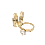 A set of three 14 karat gold rings with zirconia stones, including one engagement ring and two bands for women and men with the engraving Forever in both men and women band.