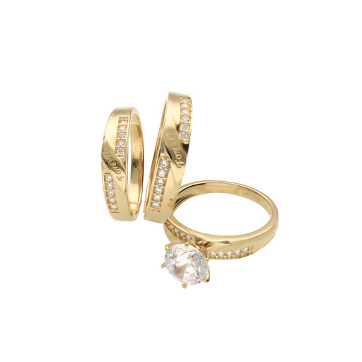 A set of three 14 karat gold rings with zirconia stones, including one engagement ring and two bands for women and men with the engraving Forever in both men and women band.
