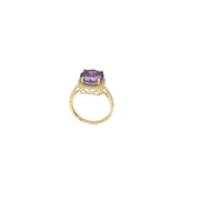 Synthetic Amethyst Stone on top a yellow real gold ring on a profile view. The purple stone is set in 4 prongs, and the base is surrounded by cubic clear zirconium stones. 