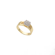A sophisticated 14 Karat Gold ring featuring a central circular cluster of sparkling stones, with additional stones embedded along the band, set against a neutral gray background.