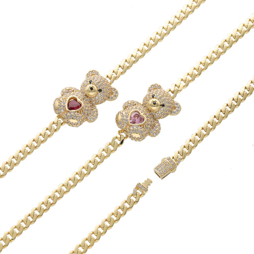 Close-up of teddy bear charm on 10K gold Cuban link bracelet showing heart detail in pink or red