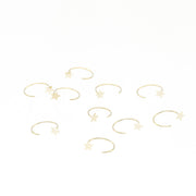 14k yellow gold open nose hoop featuring a tiny star accent. Minimalist gold nose piercing jewelry by VEKA Jewelry