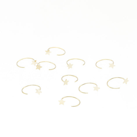 14k yellow gold open nose hoop featuring a tiny star accent. Minimalist gold nose piercing jewelry by VEKA Jewelry