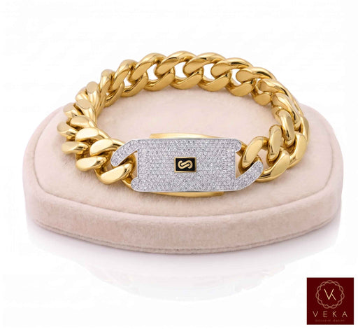 A Real 10k gold Monaco chain bracelet for men, 17mm width, showcased on a  beige velvet display stand by Veka Jewelry
