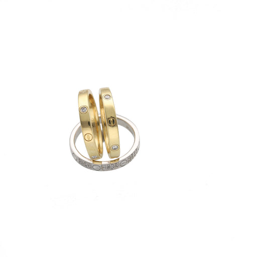 Two gold bracelets with diamond accents  and one White gold on a white background