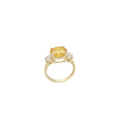 Yellow gold citrine ring with diamond-like zircon side stones - elegant three stone design in a ring display set on a white background