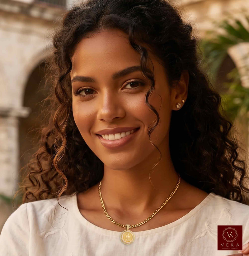 Lifestyle model wearing genuine 14K solid gold Caridad del Cobre religious medal pendant necklace by Veka Jewelry