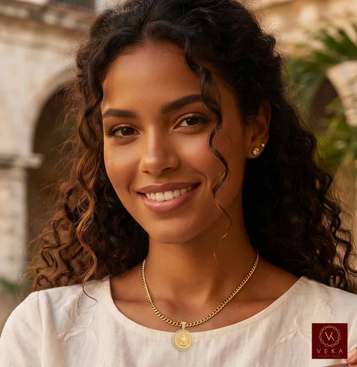 Lifestyle model wearing genuine 14K solid gold Caridad del Cobre religious medal pendant necklace by Veka Jewelry