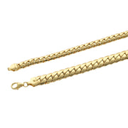 High-detail macro view of the compact "tight link" structure and high-polish finish of a 14k yellow gold Cuban bracelet with a secure lobster clasp