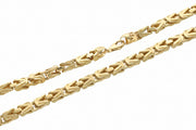 Intricate detail close-up of a high-polish 14k solid gold Byzantine chain necklace, showcasing the complex link weaving pattern