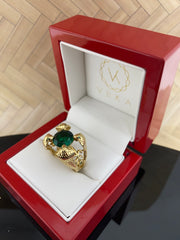Luxury red jewelry box opened to reveal the 14K gold snake ring with emerald green zirconia gemstone