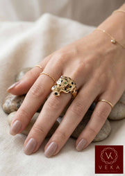 A female model wearing the VEKA Jewelry 14k gold panther ring, showing the scale and luxury fit of the piece on a finge