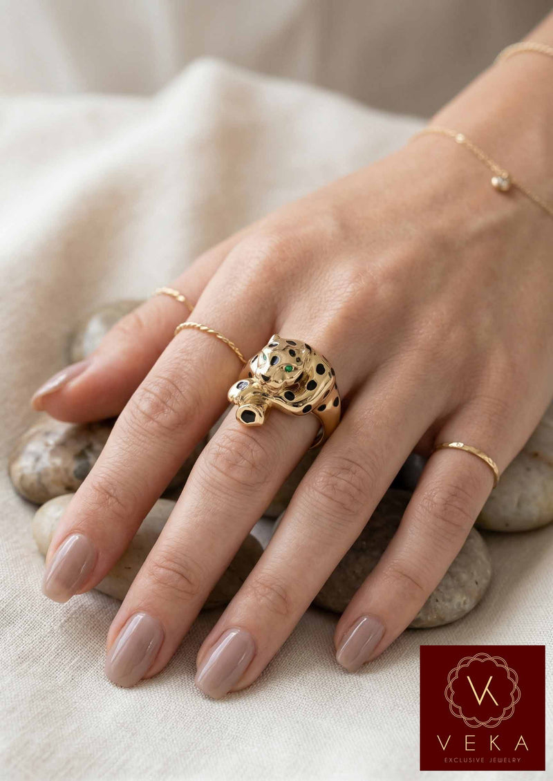A female model wearing the VEKA Jewelry 14k gold panther ring, showing the scale and luxury fit of the piece on a finge