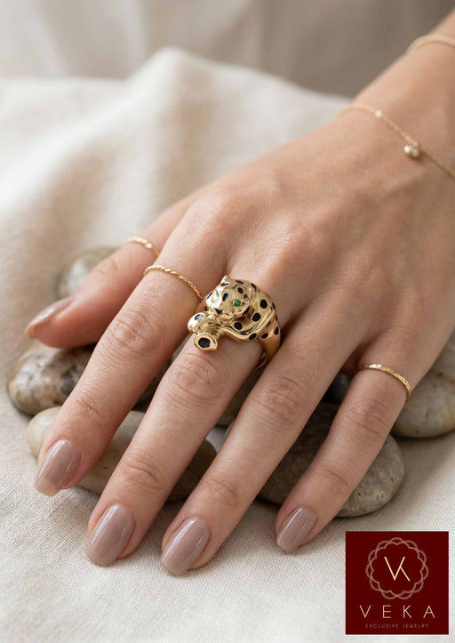 A female model wearing the VEKA Jewelry 14k gold panther ring, showing the scale and luxury fit of the piece on a finge