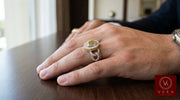 Professional model wearing the solid 10K gold crown ring with natural diamonds on a wooden surface